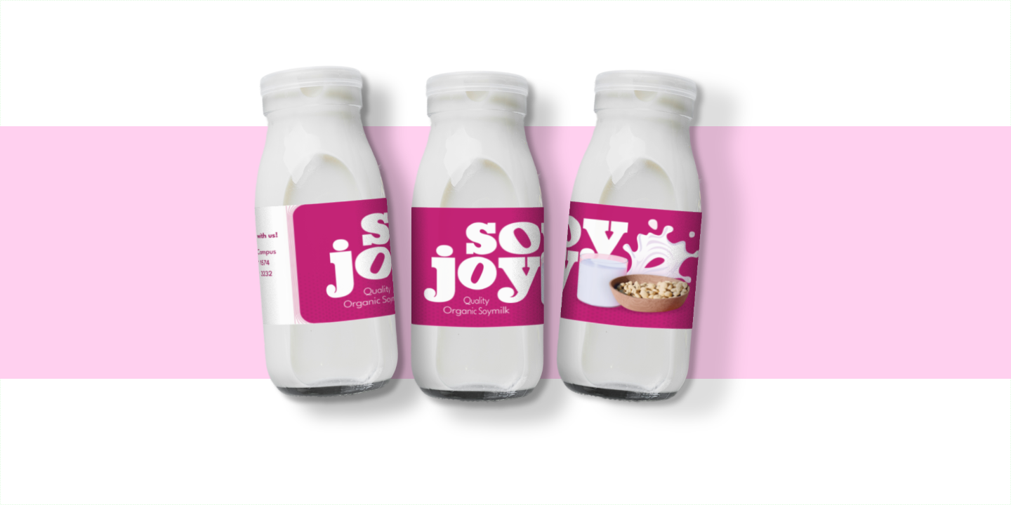 A colourful flatlay of three milk bottle with a bright magenta label showcasing the chunky wordmark logo for 'SoyJoy' organic soymilk